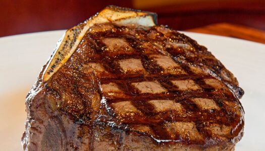 Steak with perfect grill marks looking juicy on a white plate from Kirby's Steakhouse