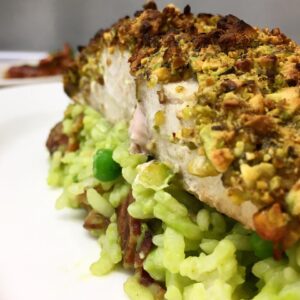 Pistachio crusted mahi-mahi over roasted corn and English pea and bacon risotto